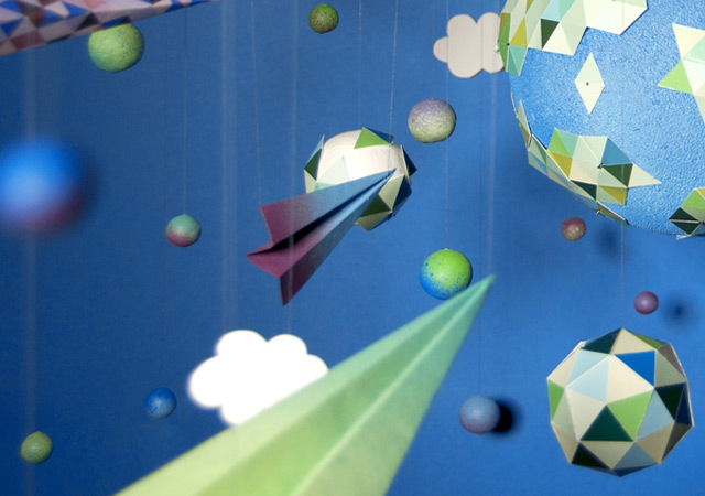 Strictlypaper - Low Gravity by Zim and Zou paper planes flying through paper clouds towards a big paper planet