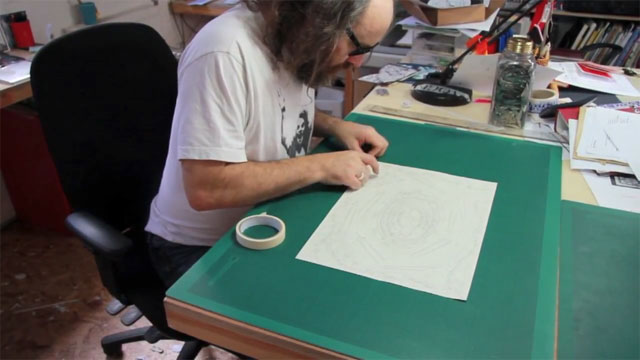 Heathrow Christmas card - Rob Ryan preparing to cut the paper Heathrow Christmas card - Rob Ryan preparing to cut the paper
