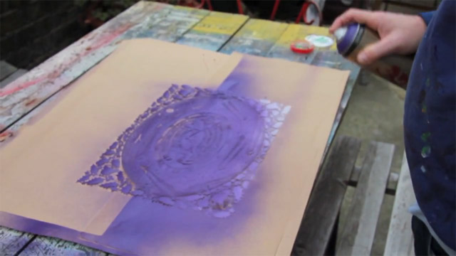 Rob Ryan spray painting the Heathrow Christmas card paper cut Rob Ryan spray painting the Heathrow Christmas card paper cut